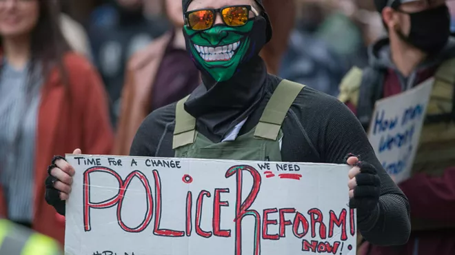 Image: As thousands march for more police accountability, a proposed Spokane Police contract could result in less