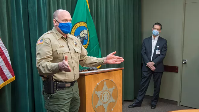 Image: At indoor press conference, sheriff and health care leaders call for volunteers to bolster COVID-weary medical system