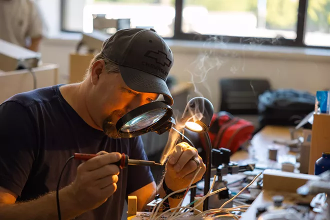 A recently graduated SCC electronics student, working on a microprocessors final project in the lab