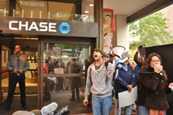 Occupy Spokane takes to the streets, goes to the bank
