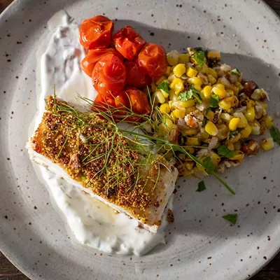 Image: Pistachio Halibut with Smoked Tomatoes and Corn Salad