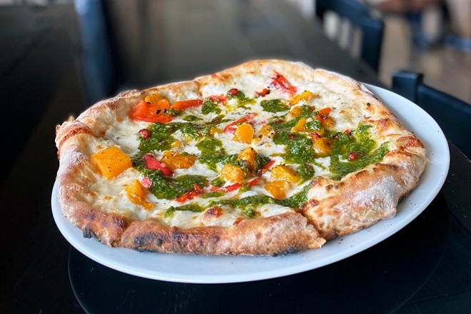 A pizza with butternut squash, roasted red peppers, mozzarella, pickled onion and chimichurri from new Roots Wood Fire in Coeur d'Alene.
