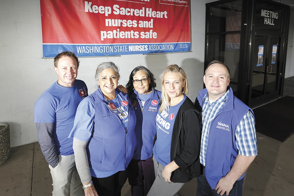 Nurses and support staff at Sacred Heart Medical Center tout their new contract agreement as a victory