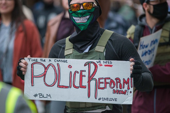As thousands march for more police accountability, a proposed Spokane Police contract could result in less