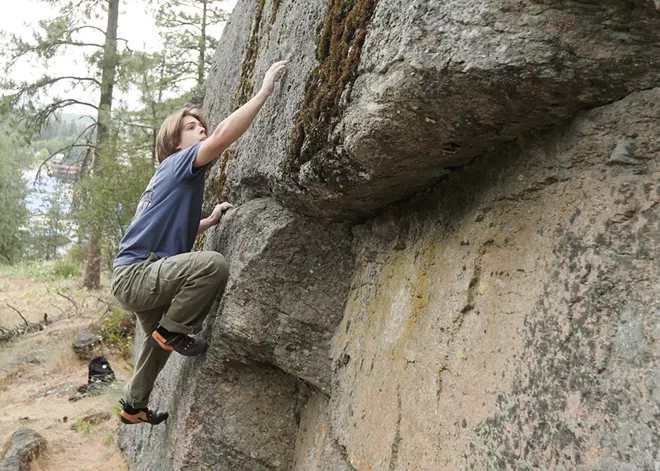 An indoor rock climber tackles Tubbs Hill bouldering in Coeur d’Alene, led by local guidebook author Owen Harro