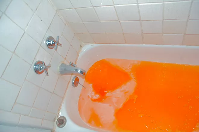 A bathtub of orange soda